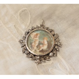 Pendentif circulaire en métal argenté et demi perle miniature putti musiciens 19ème siècle